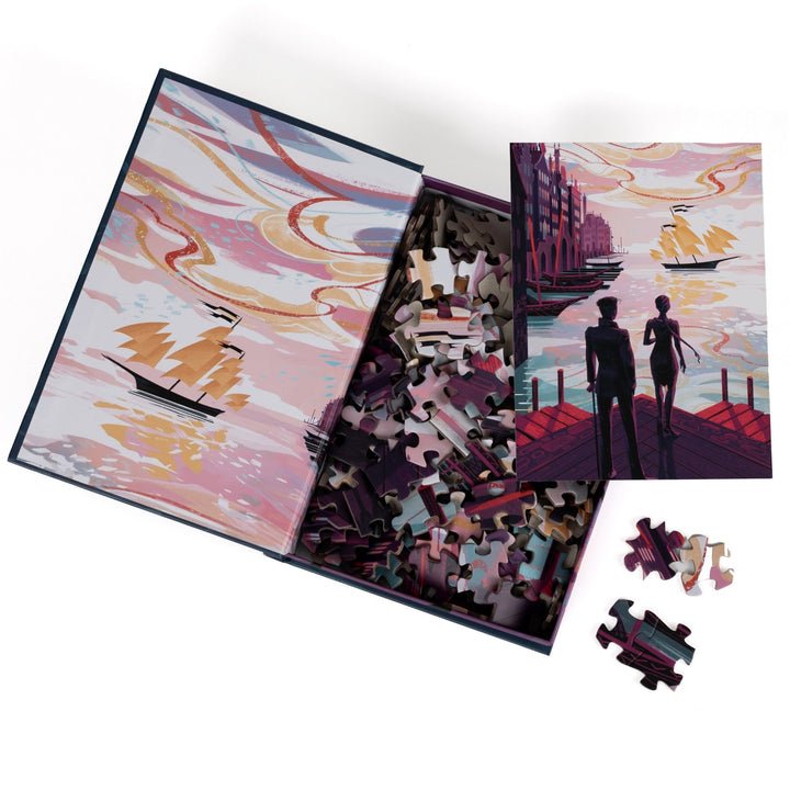 An open book-shaped box reveals puzzle pieces. Inner art on the top flap harbor with ships. An art print of Kaz and Inej on the Ketterdam docks atop the pieces.