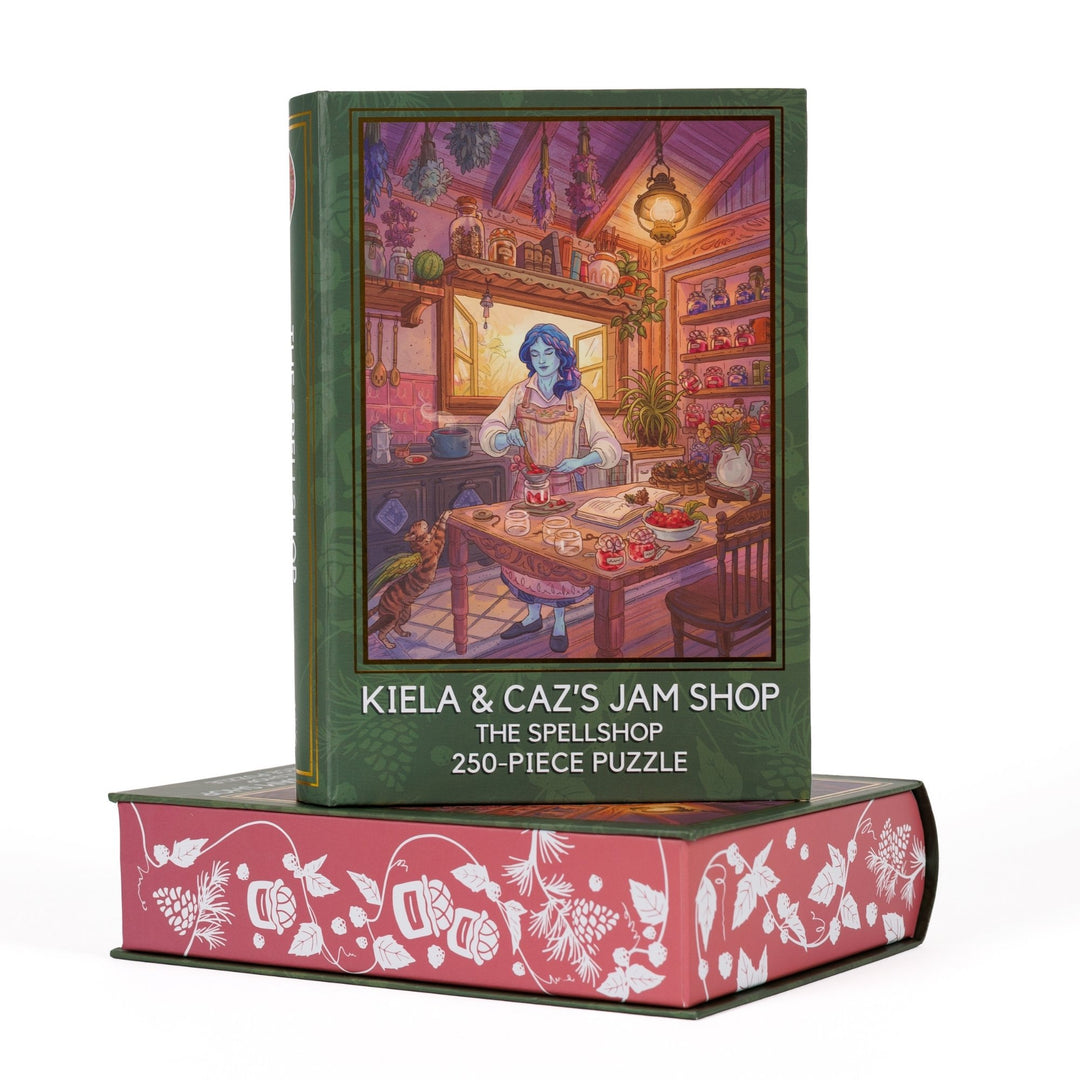Book-shaped black box for Kiela and Caz’s Jam Shop The Spellshop 250-piece puzzle. Art on the front is of Kiela making jam in her kitchen.