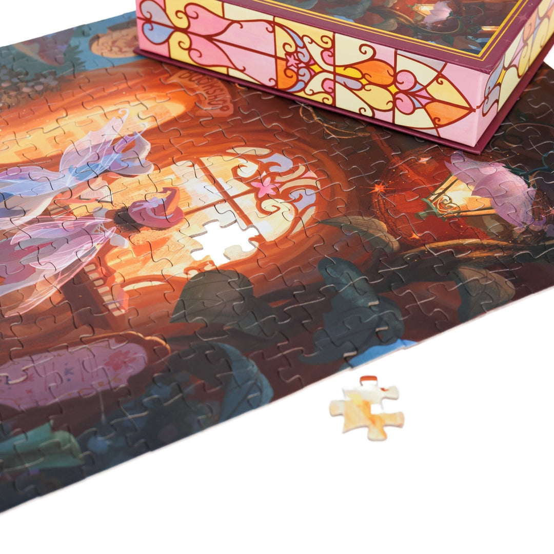 Close up of completed puzzle of two fairies looking into the window of a woodland bookstore with one piece missing.
