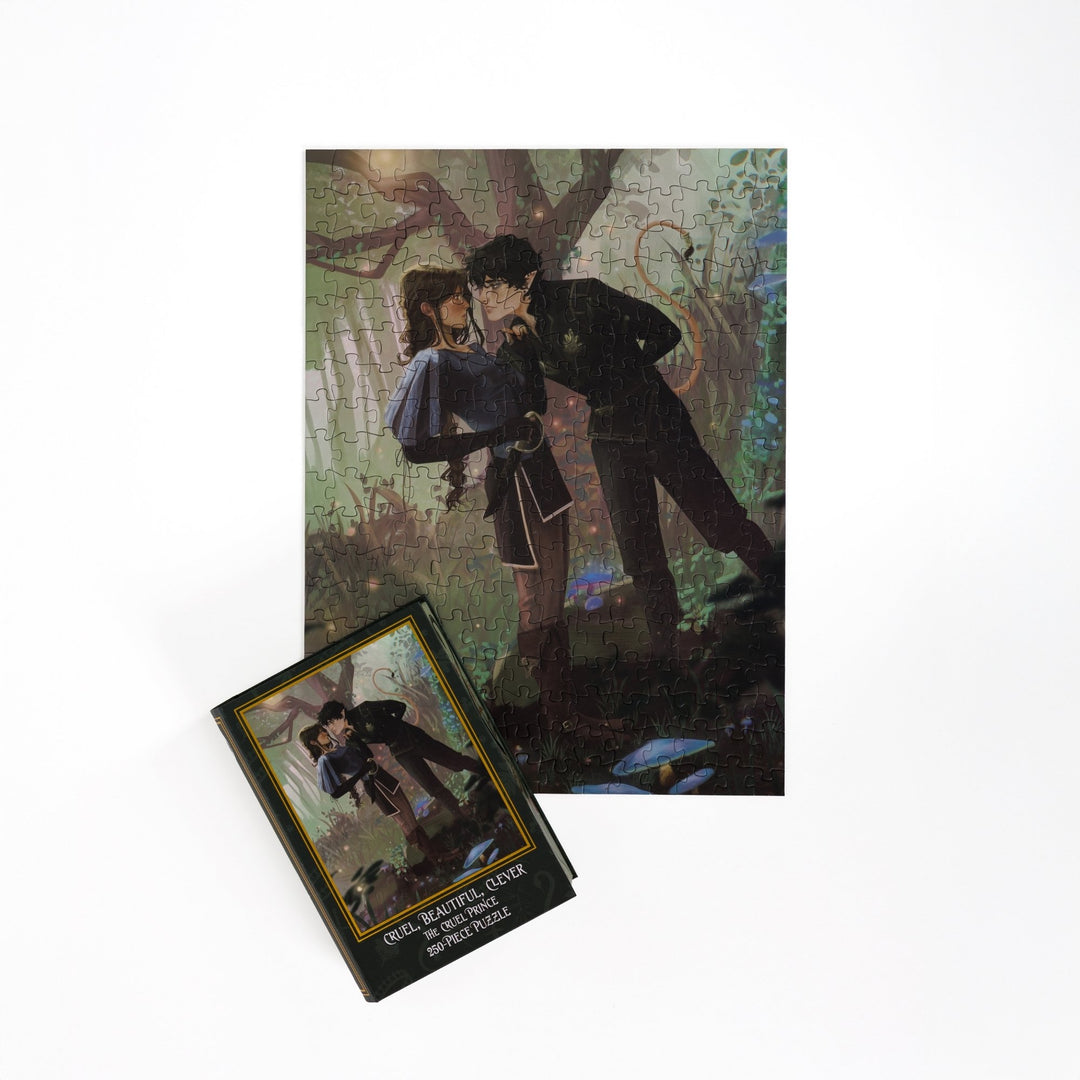 Full completed puzzle of Jude and Cardan and a green book-shaped box for Cruel, Beautiful, Clever, The Cruel Prince 250-piece puzzle.