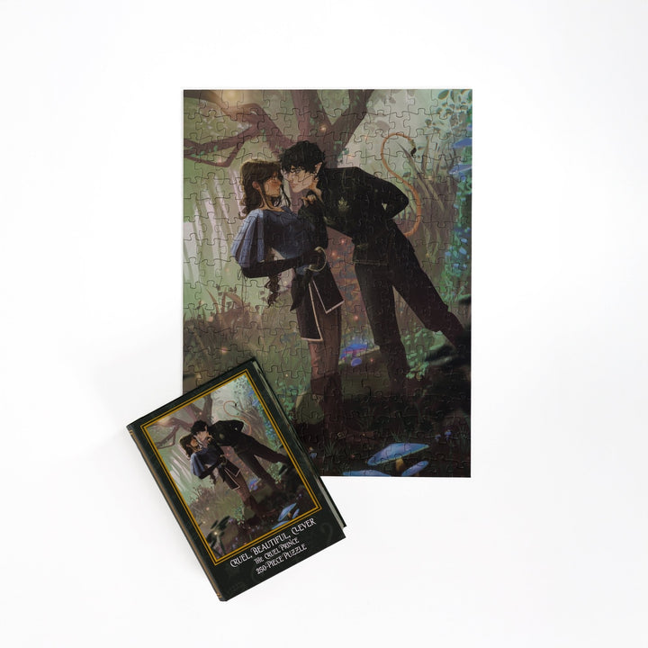 Full completed puzzle of Jude and Cardan and a green book-shaped box for Cruel, Beautiful, Clever, The Cruel Prince 250-piece puzzle.
