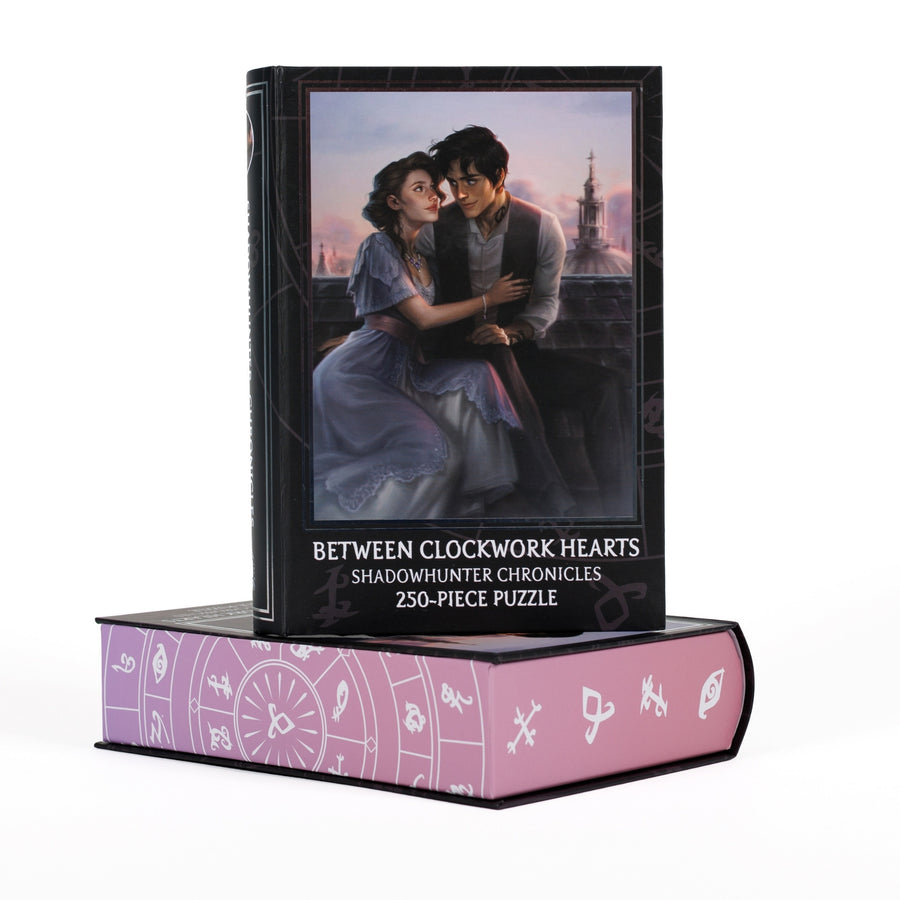 Book-shaped black box for Between Clockwork Hearts Shadowhunter Chronicles 250-piece puzzle. Art on the front is of Will and Tessa on a London rooftop.