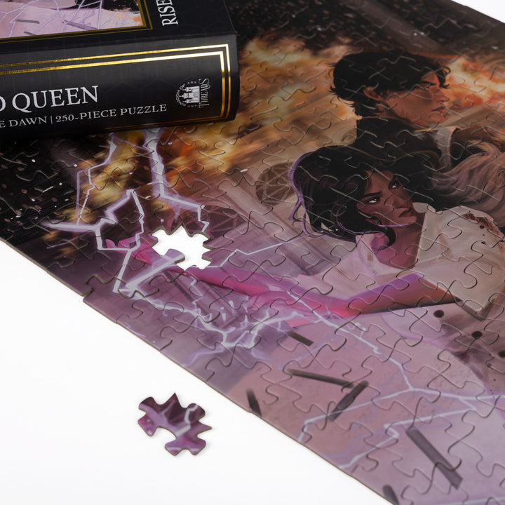Close up of completed puzzle of Mare and Cal wielding fire and lightning from Red Queen with one piece missing.