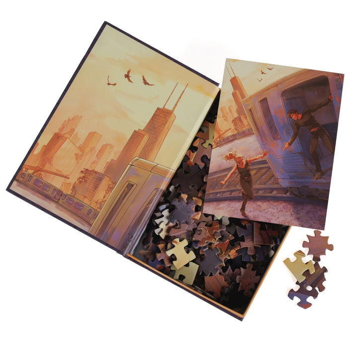 An open book-shaped box reveals puzzle pieces. Art on the inner flap of dystopian Chicago skyline. An art print of Tris and Four atop the pieces.