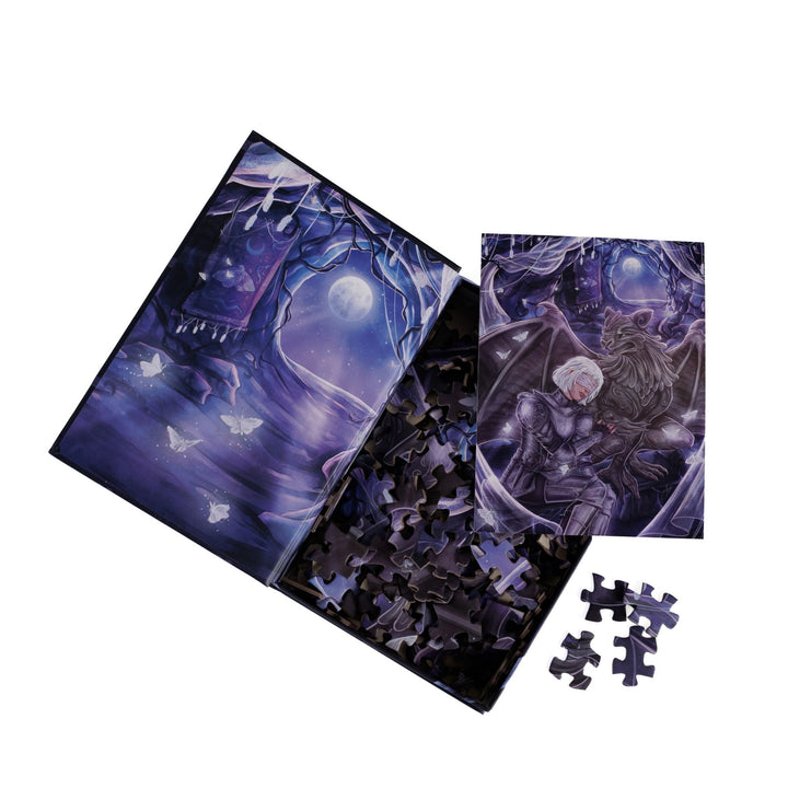 An open book-shaped box reveals puzzle pieces. Inner art on the top flap moonlit cavern with moths. An art print of Sybil and Bartholomew atop the pieces.