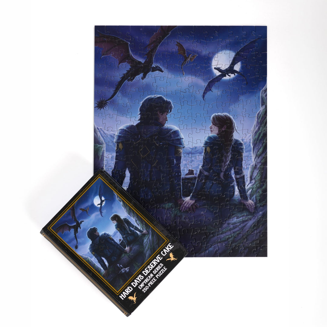 Completed puzzle of Violet and Xaden and black, book-shaped box with matching art for Hard Days Deserve Cake Fourth Wing 250-piece puzzle.