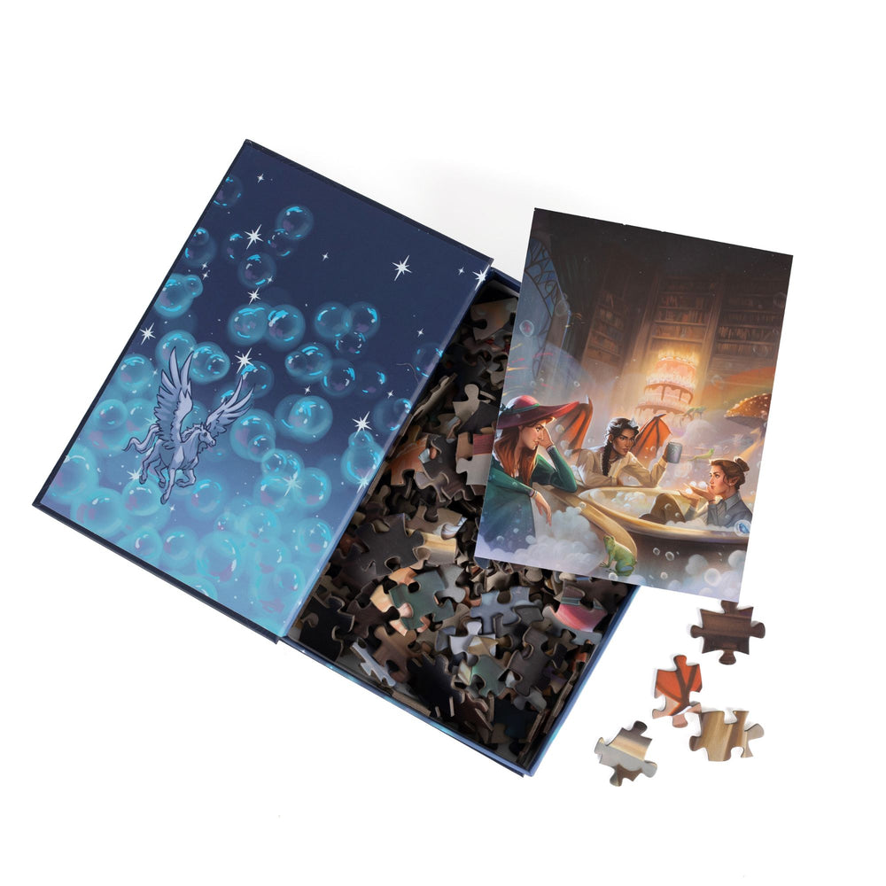 An open book-shaped box reveals puzzle pieces. Inner art on the top flap of bubbles and a mini pegasus. An art print of Nesta, Gwyn, and Emerie atop the pieces.