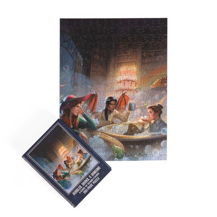 Completed puzzle of Nesta, Gwyn, and Emerie and blue, book-shaped box with matching art for Bubbles, Books, and Bonding, A Court of Thorns and Roses 250-piece puzzle.