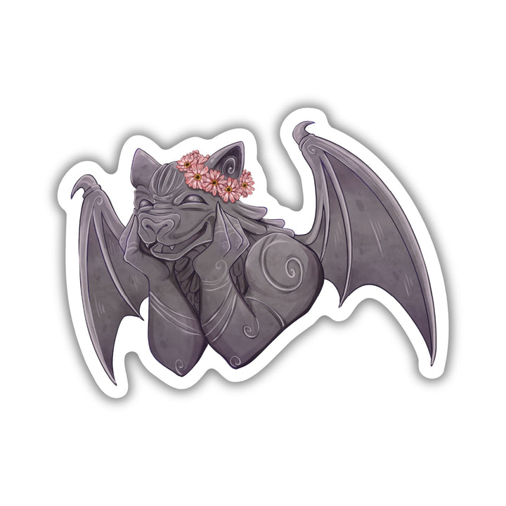 Sticker of a smiling gargoyle wearing a flower crown. Character is Bartholomew from The Knight and the Moth by Rachel Gillig.
