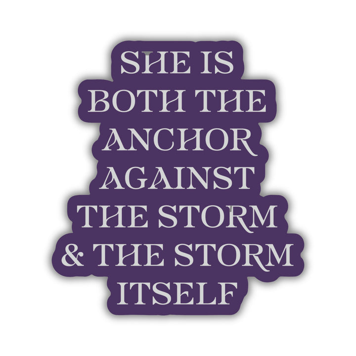 Red Queen quote sticker with silver text on a purple background. Text reads ‘She is both the anchor against the storm and the storm itself.’