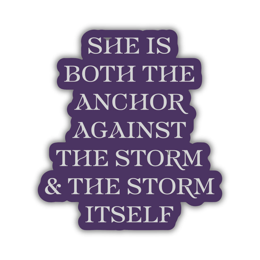 Red Queen quote sticker with silver text on a purple background. Text reads ‘She is both the anchor against the storm and the storm itself.’