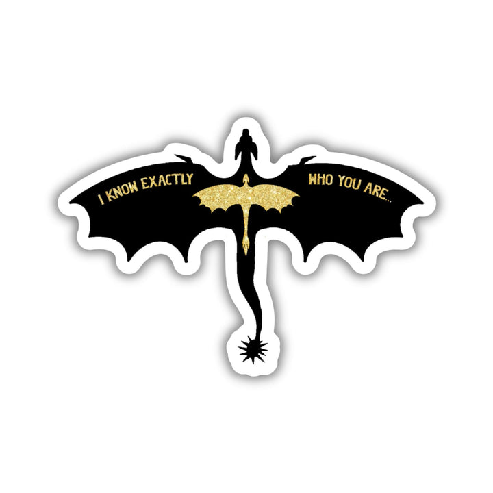 Sticker of a silhouette of a black dragon, wings spread, with a smaller glittery gold dragon overlaid. Quote on the wings is 'I know exactly who you are.' From Fourth Wing.