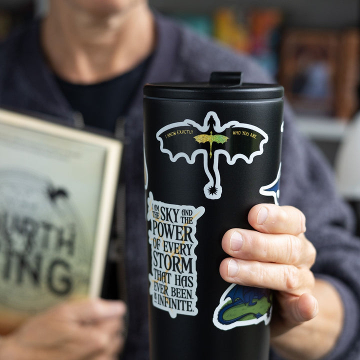  Sticker of a black dragon & holographic gold dragon in flight, on a black tumbler. Quote on wings: ‘I know exactly who you are.’
