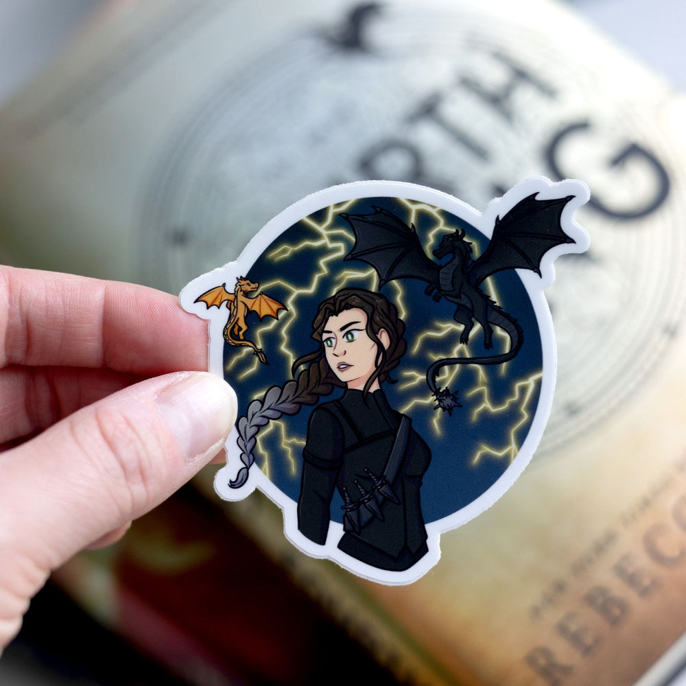 Sticker of Violet Sorrengail in riding leathers with her dragons Tairn & Andarna. The sticker is held over Fourth Wing.
