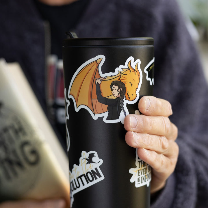 Sticker of Violet Sorrengail hugging her golden dragon, Andarna. Characters from Fourth Wing. On a black tumbler.