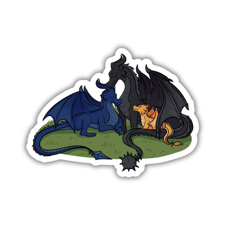 Sticker of 3 dragons - a blue and a black adult with a golden baby dragon - cuddled up like a family. 