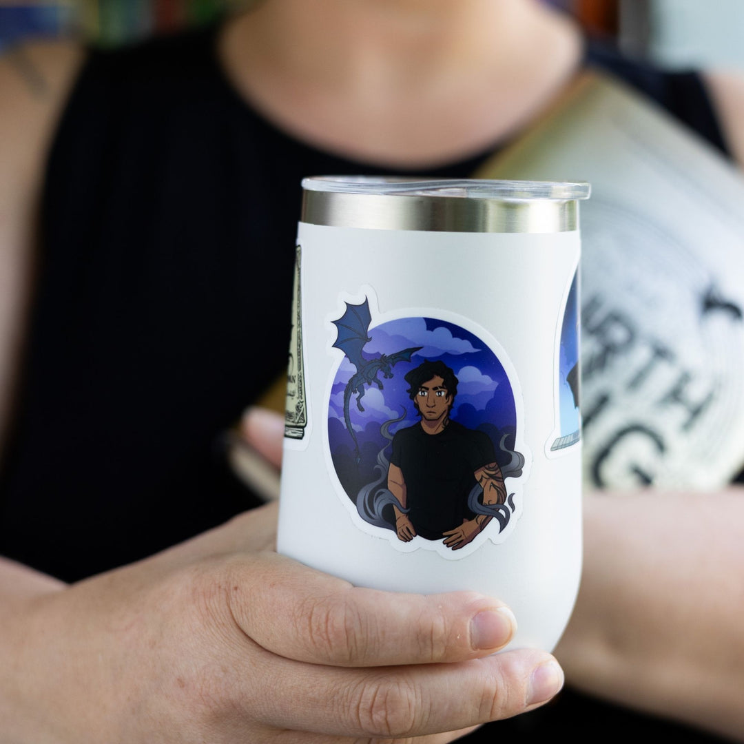 Sticker of Xaden Riorson with Sgaeyl flying behind him in a purple cloudy sky. Characters from Fourth Wing. On a white tumbler.