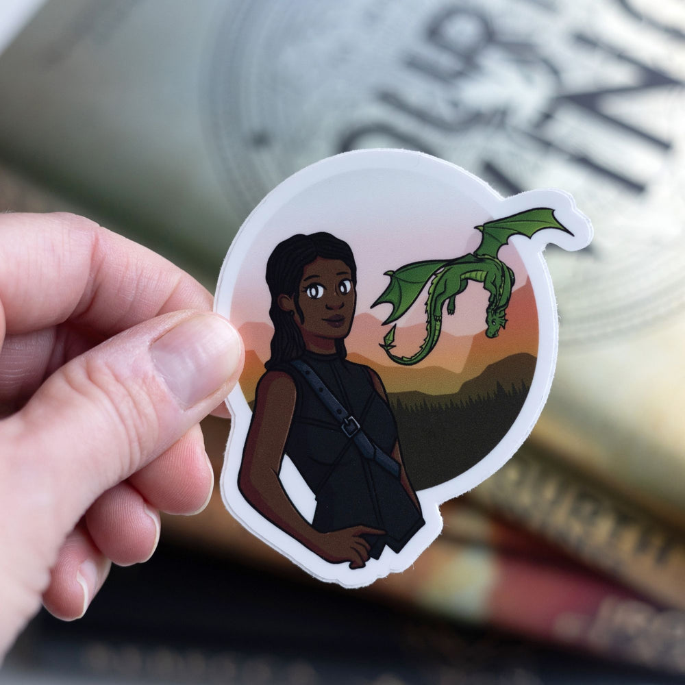 Sticker of Rhiannon in black riding leathers with her green dragon Feirge flying behind her. Held over Fourth Wing.
