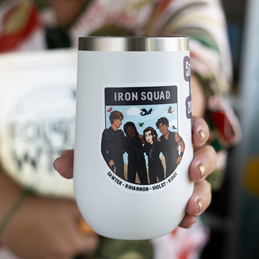  Sticker of the Iron Squad in riding leathers, arm in arm and smiling, with dragons flying behind them. Their names ‘Sawyer, Rhiannon, Violet, and Ridoc’ are on the bottom. On a white tumbler