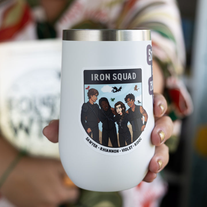  Sticker of the Iron Squad in riding leathers, arm in arm and smiling, with dragons flying behind them. Their names ‘Sawyer, Rhiannon, Violet, and Ridoc’ are on the bottom. On a white tumbler