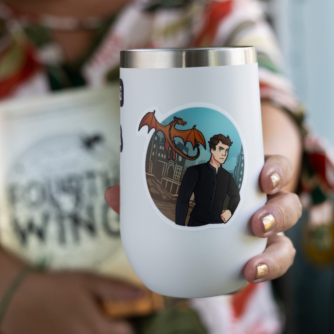 Sticker of Brennan in a black shirt with a castle behind him and a golden dragon flying in the background. On a white tumbler.
