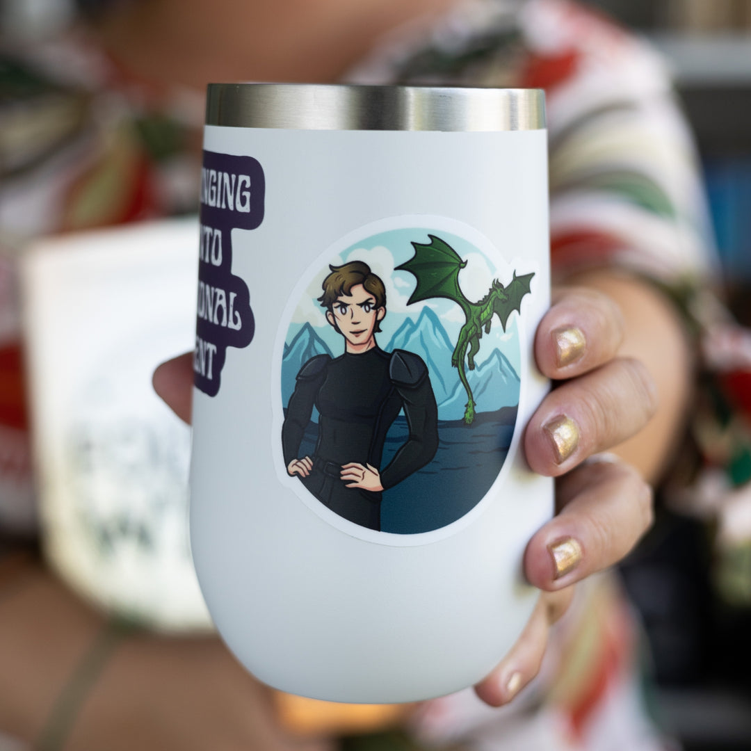 Sticker of Mira in black riding leathers with the sea, mountains, and a green dragon flying behind her. On a white tumbler.
