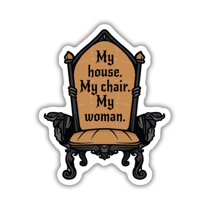 Sticker of chair with dark gold upholstery with the Fourth Wing quote: ‘My house. My chair. My woman.’
