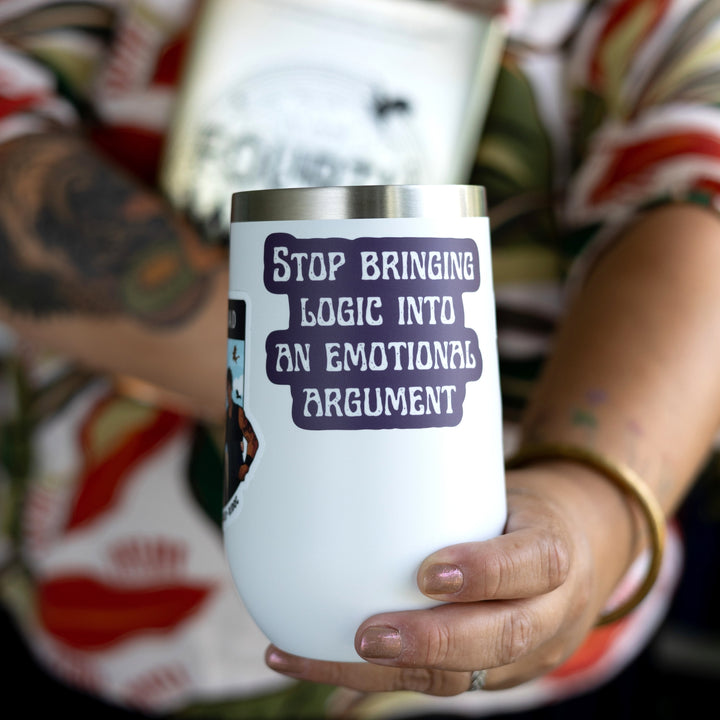 Fourth Wing quote sticker: ‘Stop bringing logic into an emotional argument.’ In white letters on a purple background. On a white tumble