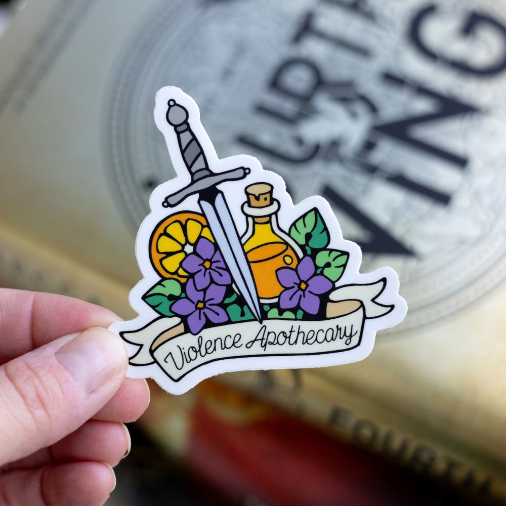  Sticker of a dagger, potion bottle, orange slice, and purple flowers above a banner that reads ‘Violence Apothecary.’ Held over Fourth Wing.