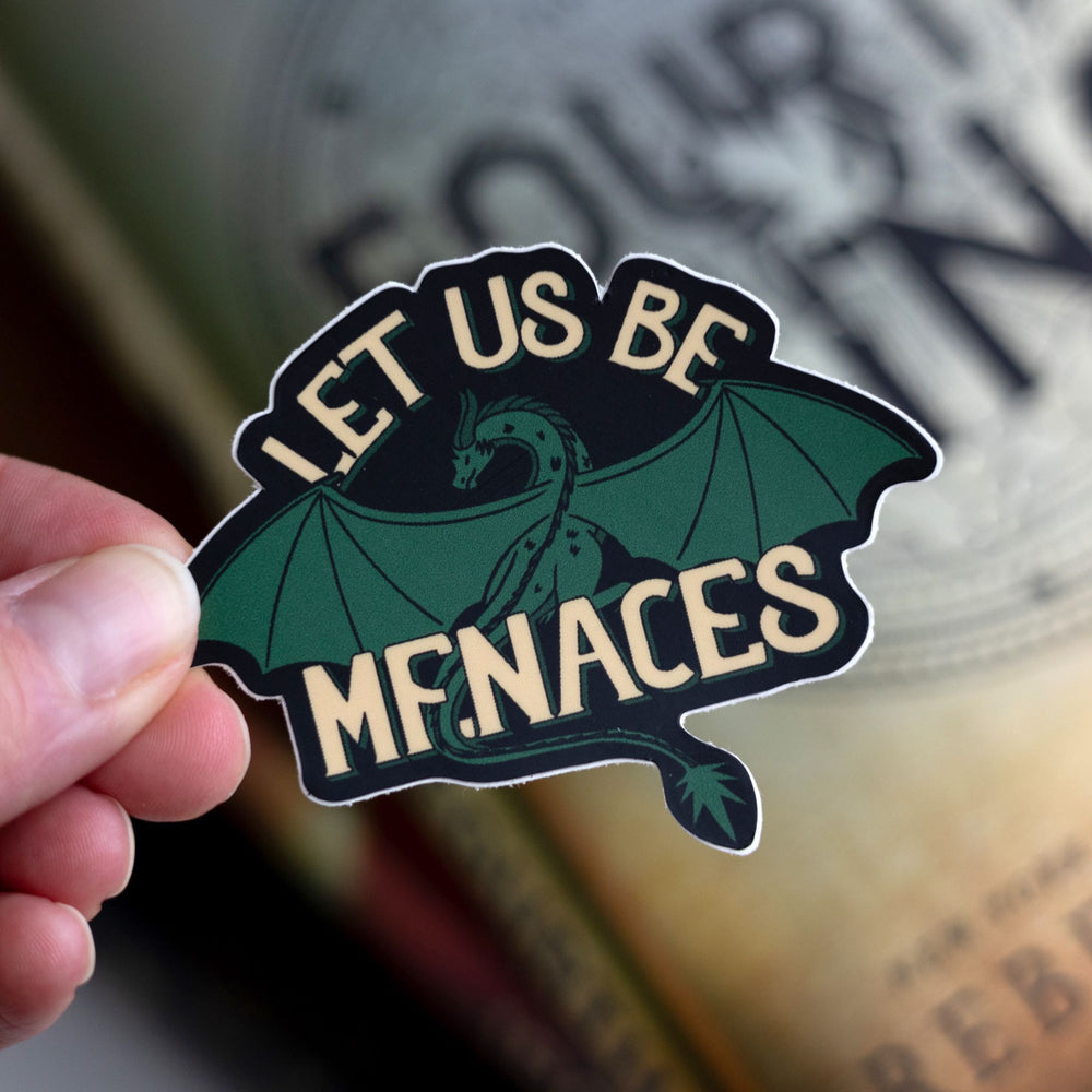  Feirge, a green dragon from Fourth Wing, with text that reads ‘Let us be menaces.’ Held over Fourth Wing.