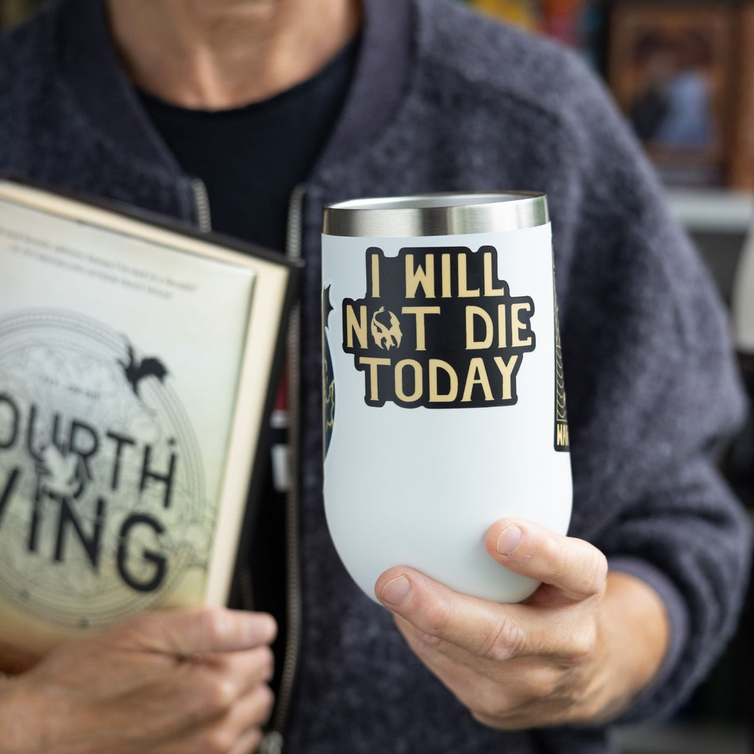 Sticker of Violet Sorrengail’s mantra ‘I will not die today’ in gold text on a black background. Sticker is on a white tumbler