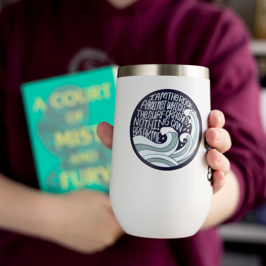  ACOTAR quote sticker ‘I am the rock against which the surf crashed nothing can break me.’ With waves coming up by the words. On a white tumbler.
