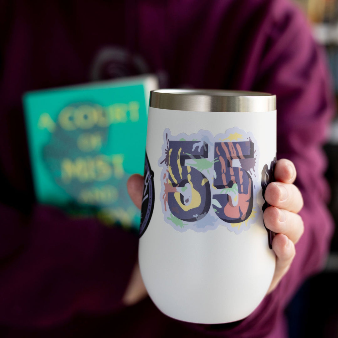 Sticker of a purple number 55 with different paint splatter colors all over it, from ACOTAR. On a white tumbler.

