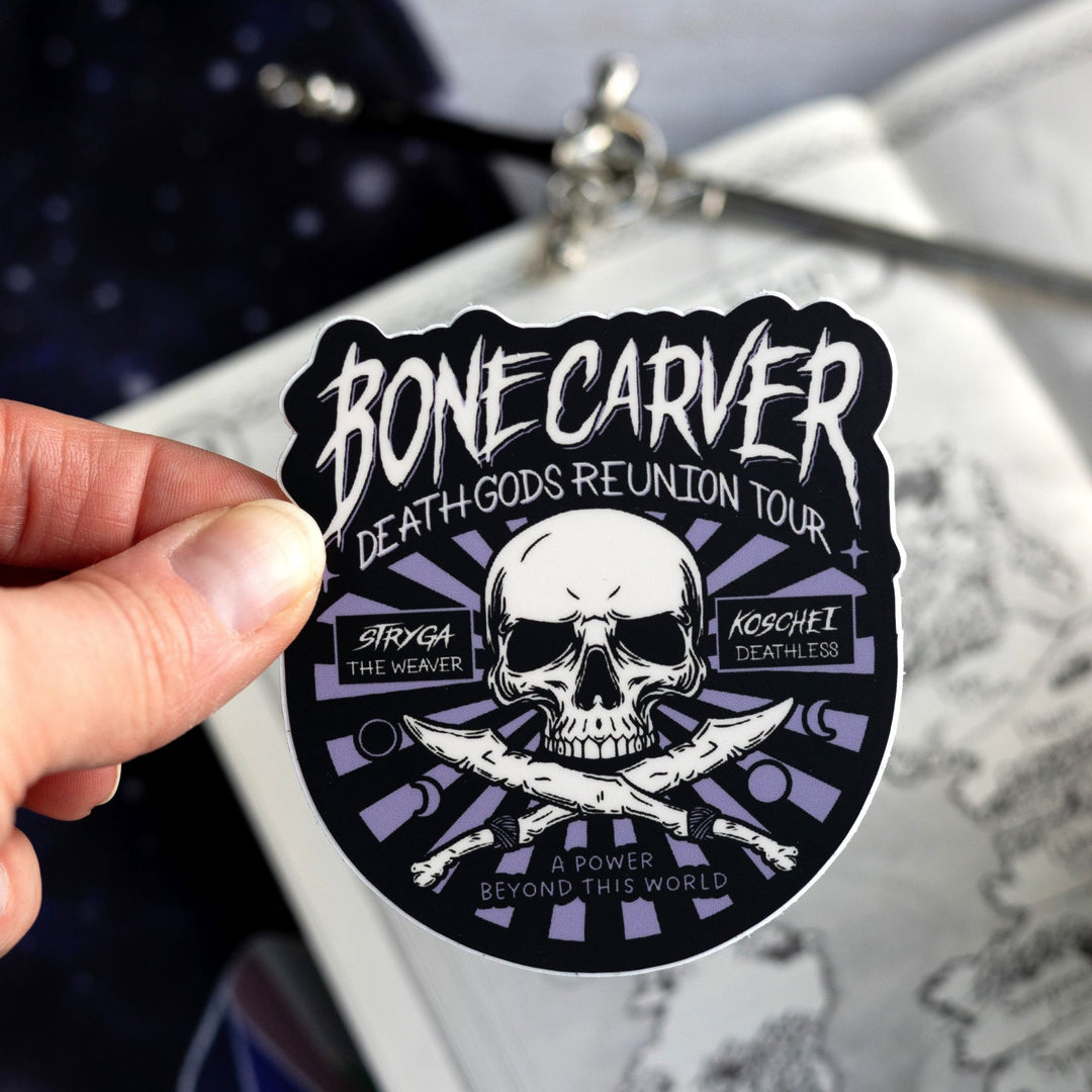  Sticker in a concert poster style with a skull that reads ‘Bonecarver Death Gods Reunion Tour, Stryga the Weaver, Koschei Deathless, a power beyond this world.’ Held above a map.
