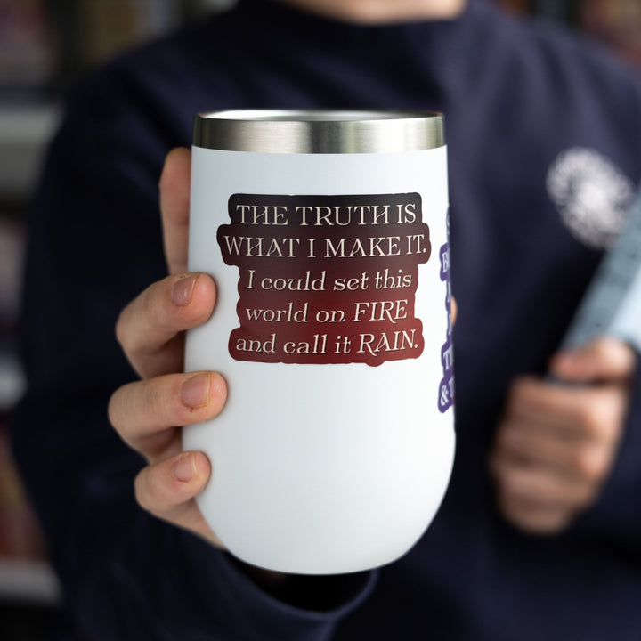 Red Queen quote sticker with tan text on a red background on a white tumbler. Text reads ‘The truth is what I make it. I could set this world on fire and call it rain.’