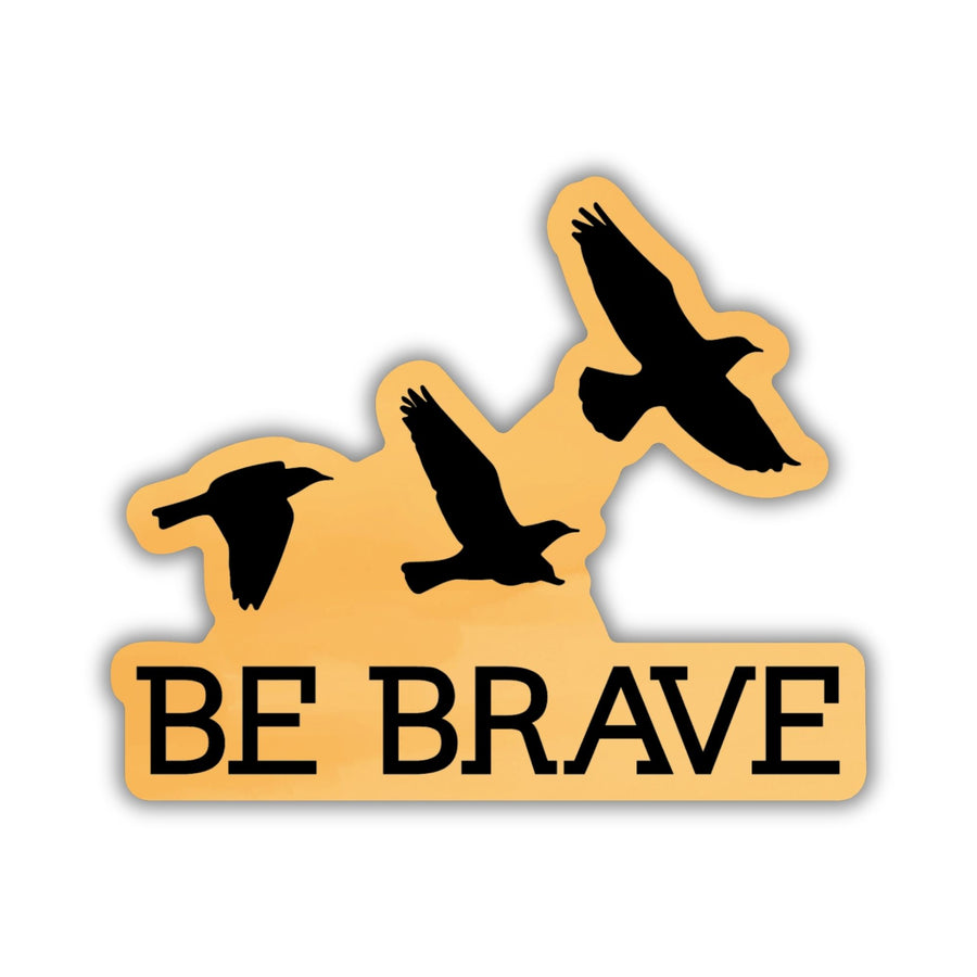 Sticker with ‘Be Brave’ and three flying ravens in black on a gold background. From Divergent by Veronica Roth.